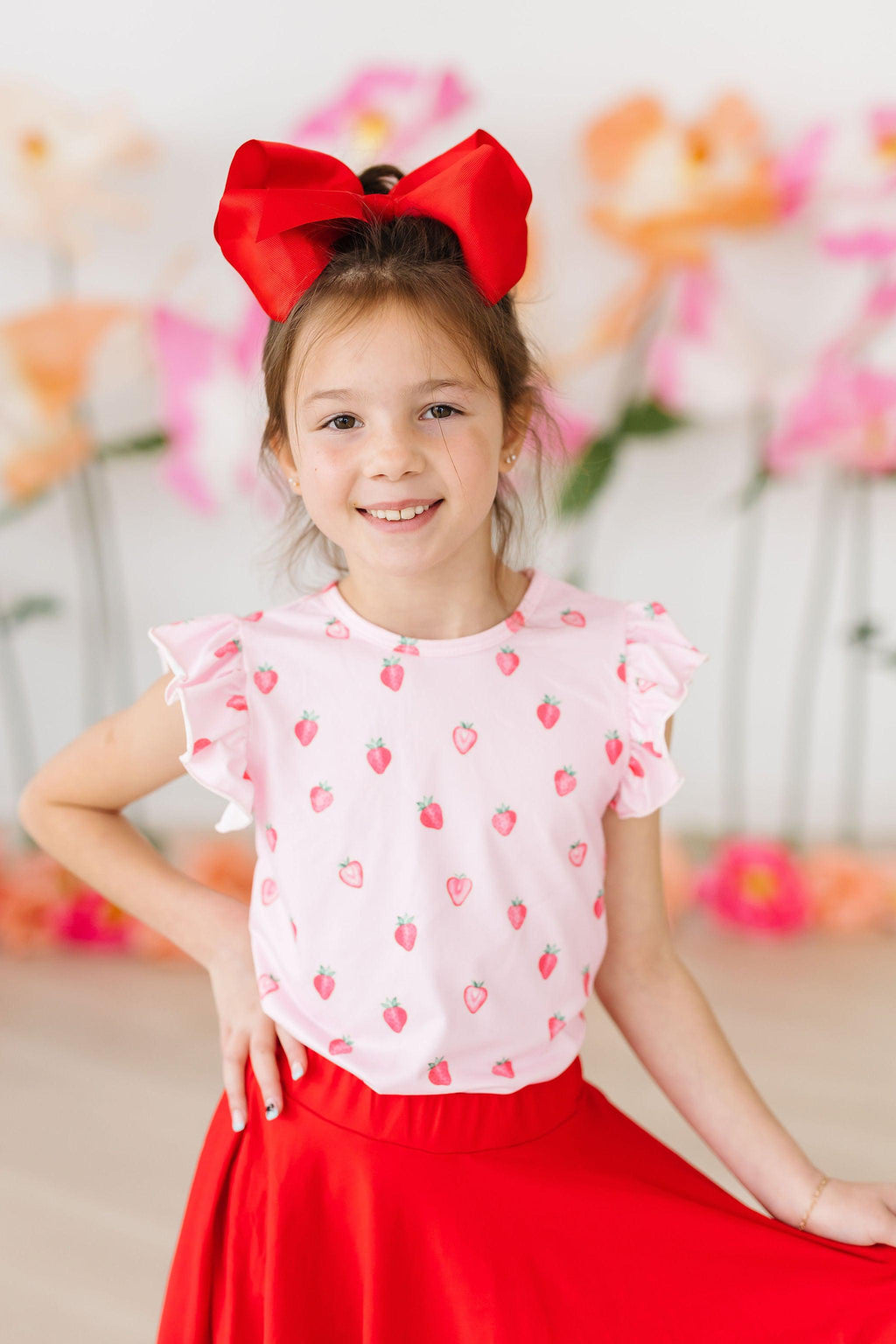 Mila & Rose sweet strawberry print short-sleeve ruffle tee for babies, featuring a soft cotton fabric and cute ruffle details.