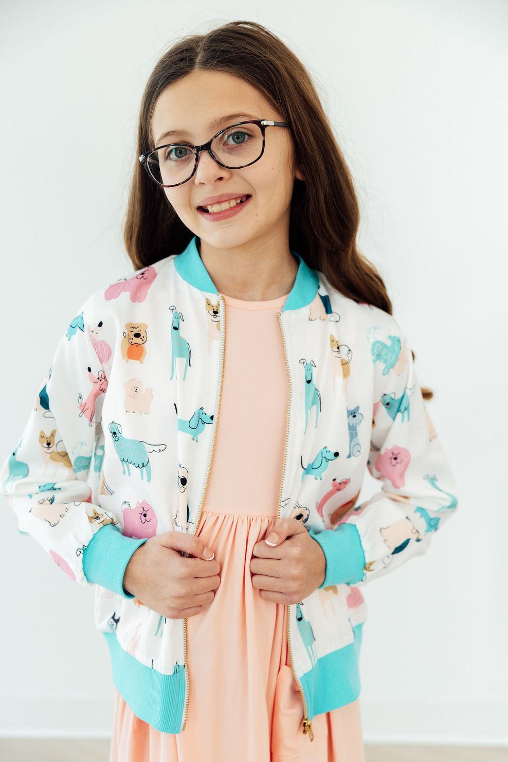 Mila & Rose Puppy Pals satin jacket for toddlers, featuring a soft, shiny fabric with playful puppy design and front zipper closure.