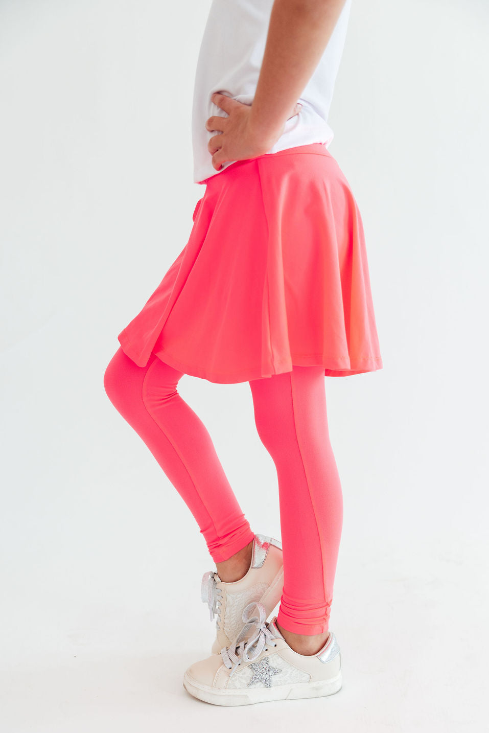 Neon pink Mila & Rose® twirl skegging featuring a vibrant color and fitted style, shown on a model.