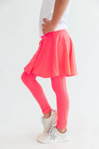 Neon pink Mila & Rose® twirl skegging featuring a vibrant color and fitted style, shown on a model.