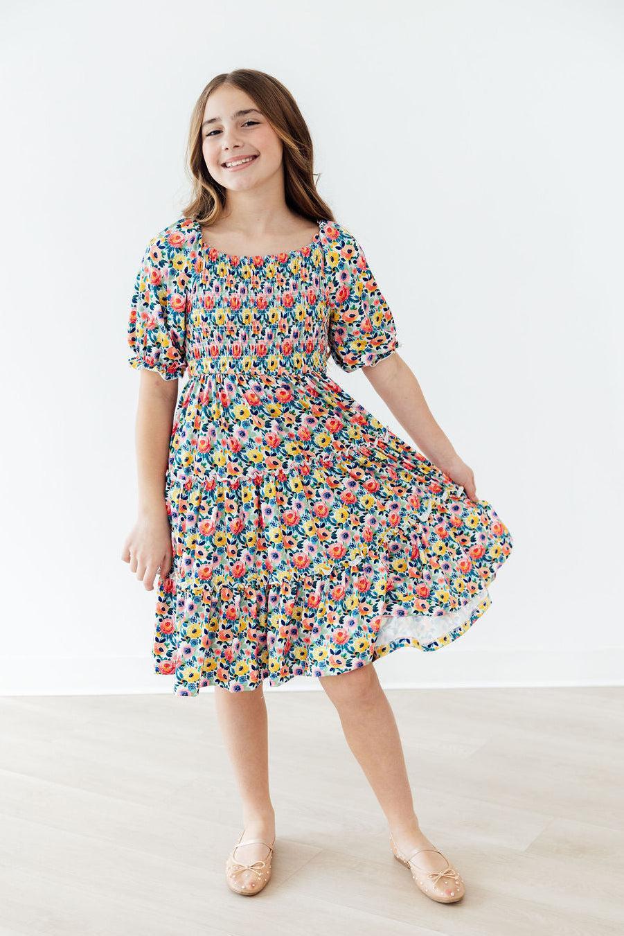 Mila & Rose® smocked ruffle dress for toddlers with a beautiful blossom print and delicate ruffled details.