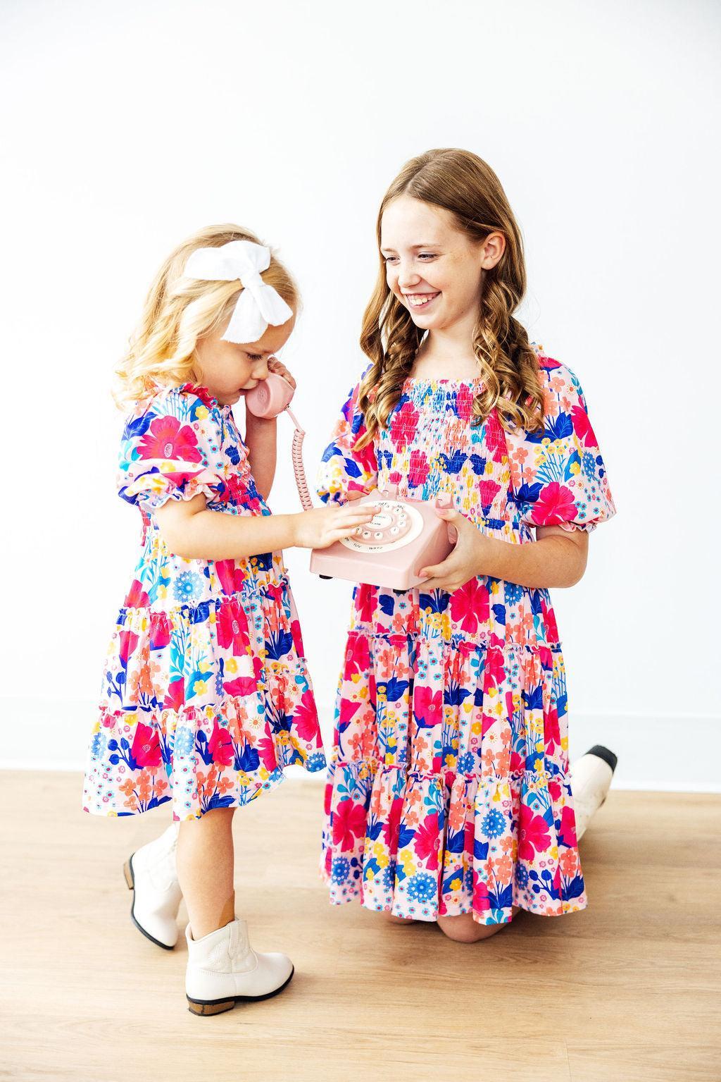 Mila & Rose® Sunshine Garden smocked ruffle dress for toddlers, featuring floral print, ruffled sleeves, and smocked bodice.