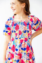 Mila & Rose Sunshine Garden smocked ruffle dress for toddlers, featuring floral print, ruffled sleeves, and smocked bodice.