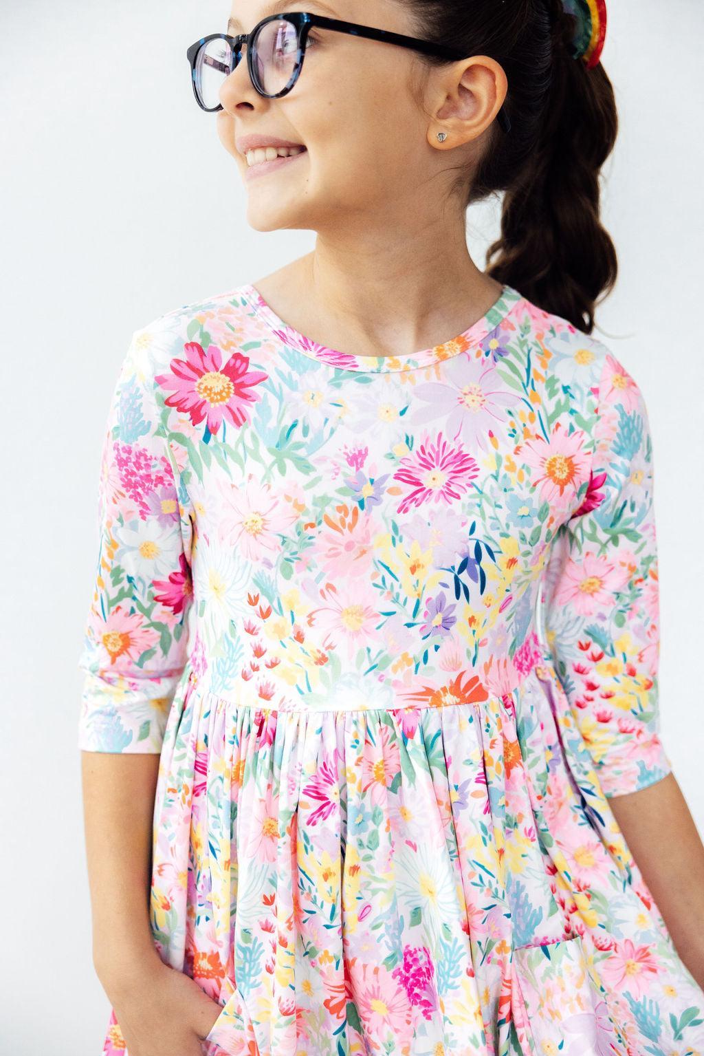 Mila & Rose Field of Flowers 3/4 Sleeve Pocket Twirl Dress for girls, featuring a floral pattern, pockets, and a twirl skirt design.