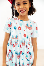 Mila & Rose® Home of the Brave short-sleeve pocket twirl dress for babies, featuring a playful design for young children.