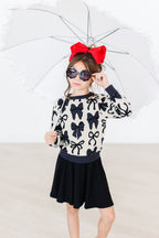 Black Mila & Rose twirl skort for girls aged 6-12 months, featuring a playful twirl design and comfortable fabric.