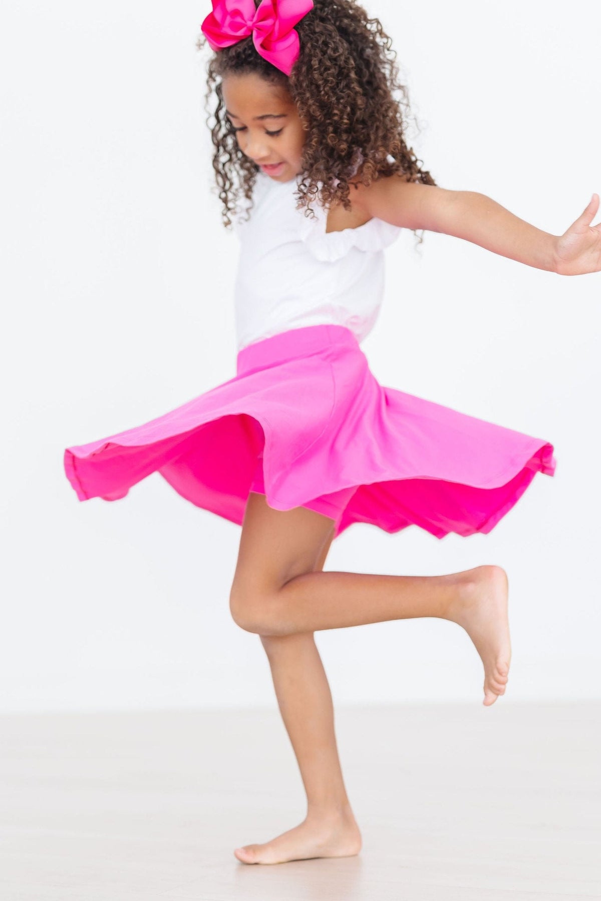 Hot pink Mila & Rose Twirl Skort for 6-12 months, showcasing a playful, twirling design with a comfortable elastic waistband.
