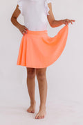 Neon coral Mila & Rose twirl skort for girls in size 6-12 months, featuring a playful, twirling design and elastic waistband.