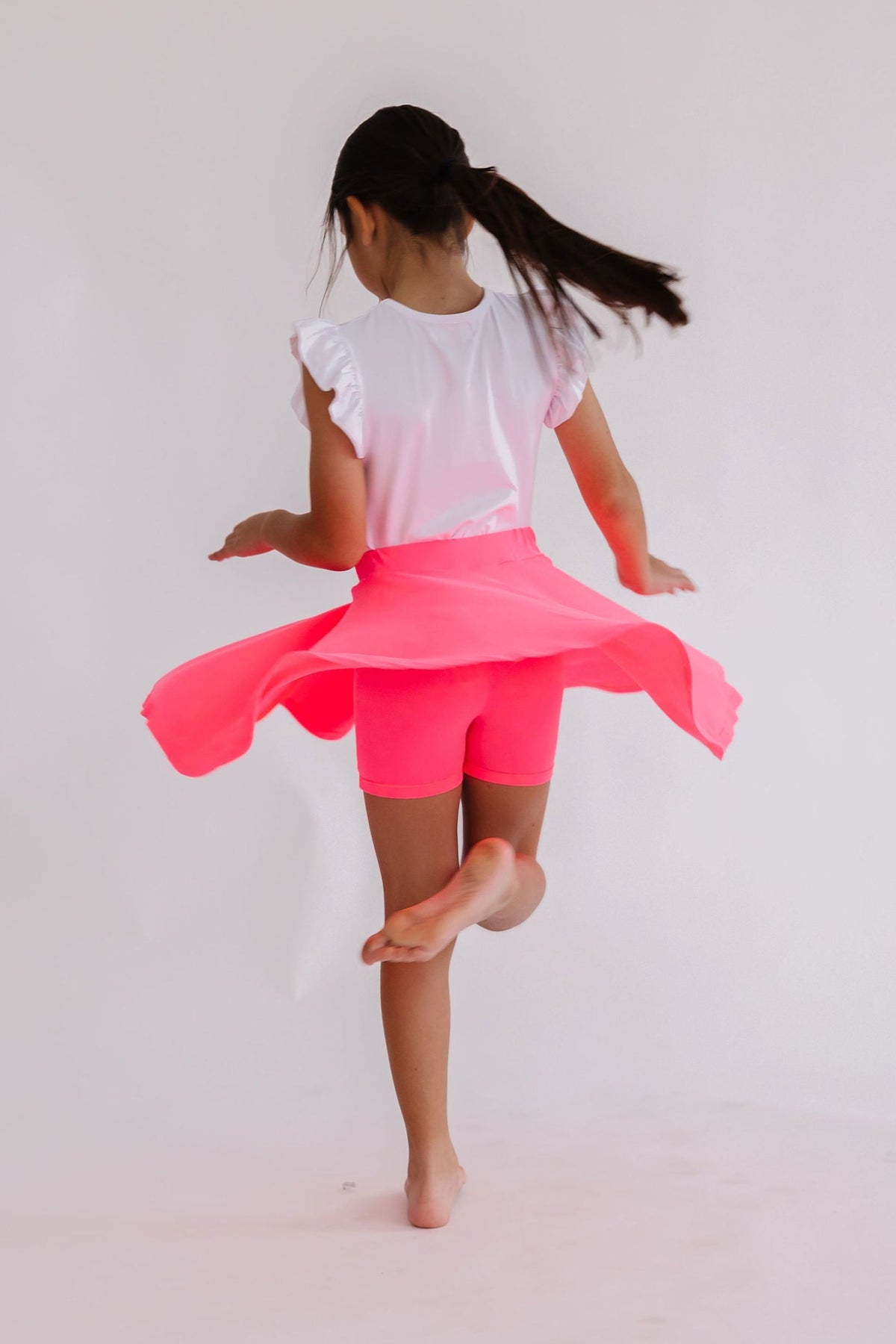 Neon pink Mila & Rose twirl skort for toddlers, with a playful flared design and comfortable elastic waistband.