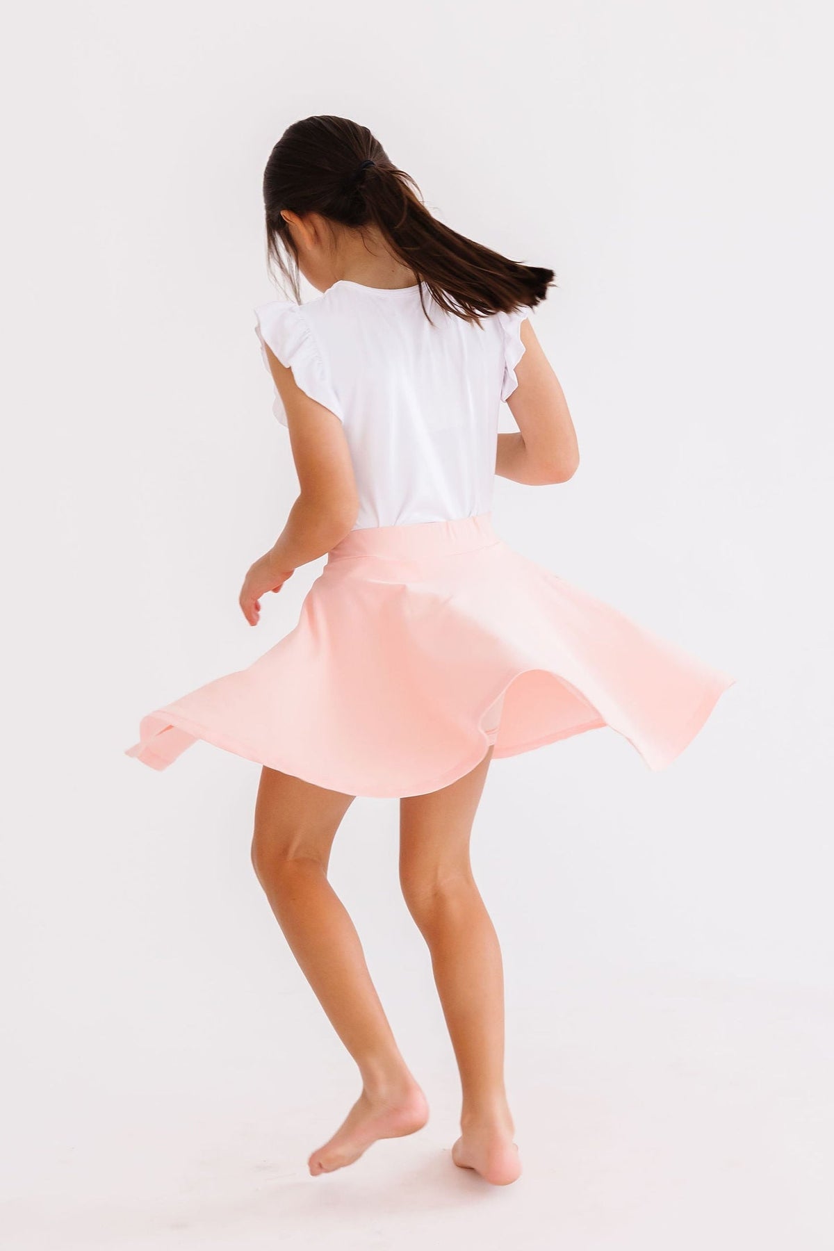 Mila & Rose peach twirl skort for girls aged 6-12 months, featuring a playful, twirling design with comfortable fabric.