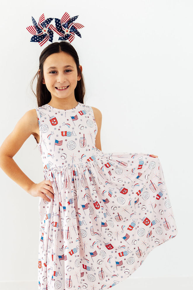 Mila & Rose baby girl twirl tank dress in "Born in the USA" print, pink and white, soft fabric perfect for warm weather.