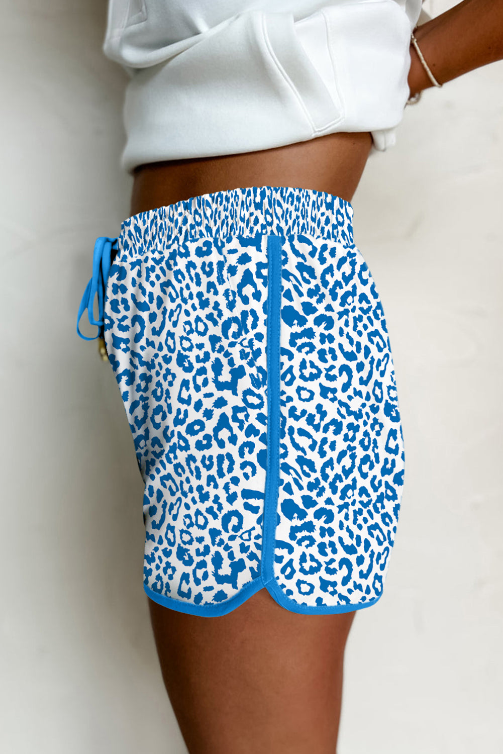 Pink leopard print casual shorts from Mommas Hive with elastic waist, lace-up front, and contrast trim, made from polyester and elastane.
