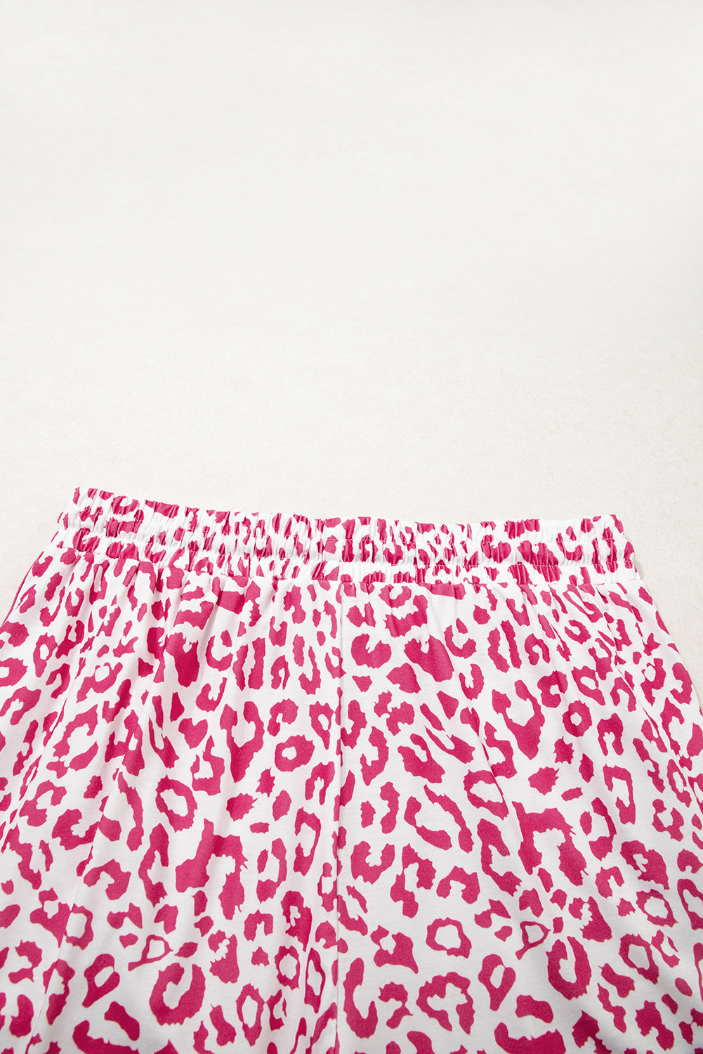 Pink leopard print casual shorts from Mommas Hive with elastic waist, lace-up front, contrast trim, made from polyester and elastane.