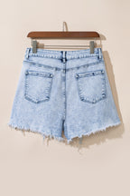 Light blue acid wash denim shorts from Mommas Hive with crossed raw edges and a casual, distressed style.