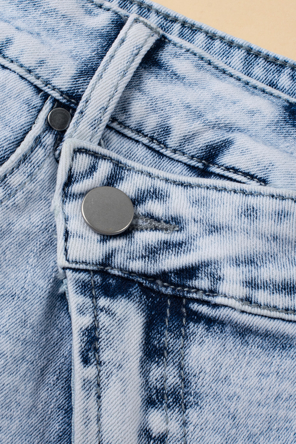 Light blue acid wash crossed raw edge denim shorts by Mommas Hive, casual bottoms with distressed finishing and comfortable stretch fabric.