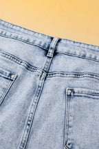 Light blue acid wash crossed raw edge denim shorts by Mommas Hive, casual bottoms with distressed style and raw hem detail.