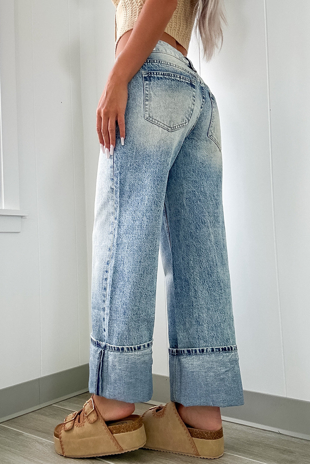 Mommas Hive Myosotis high-rise medium wash jeans with button and zip fly, made of cotton, polyester, and elastane for a comfortable fit.