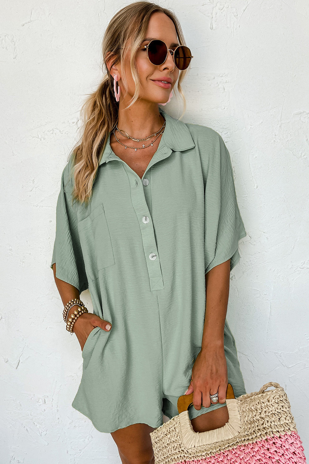 Bright pink Mommas Hive loose romper with half-button collar, made of 100% polyester, featuring a relaxed fit and casual style.