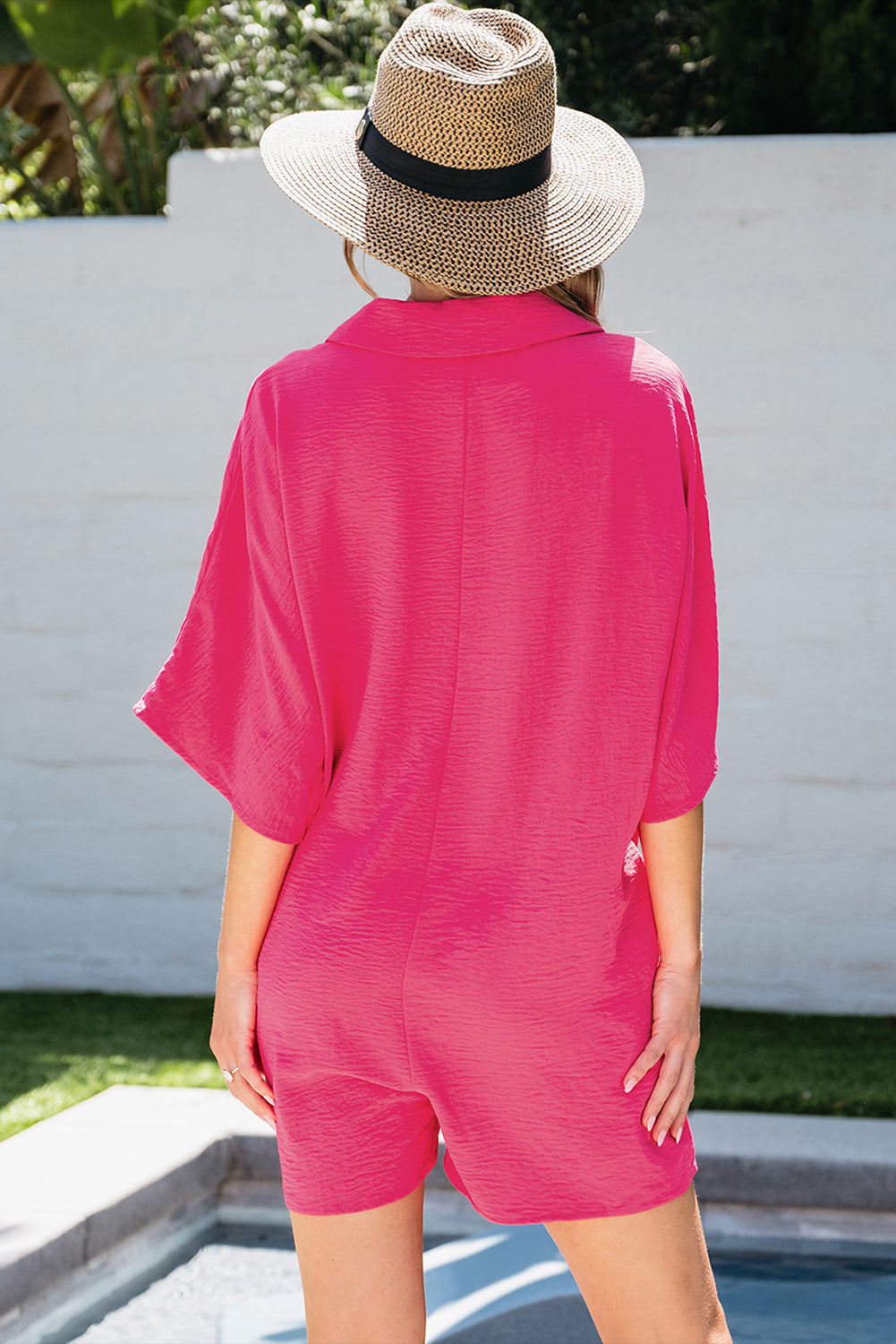Bright pink Mommas Hive half-button collared loose romper, made of 100% polyester, featuring a stylish jumpsuit design.