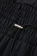 Plain sleeveless Mommas Hive romper with cinched waist and drawstring, made of polyamide and elastane, shown on a hanger.