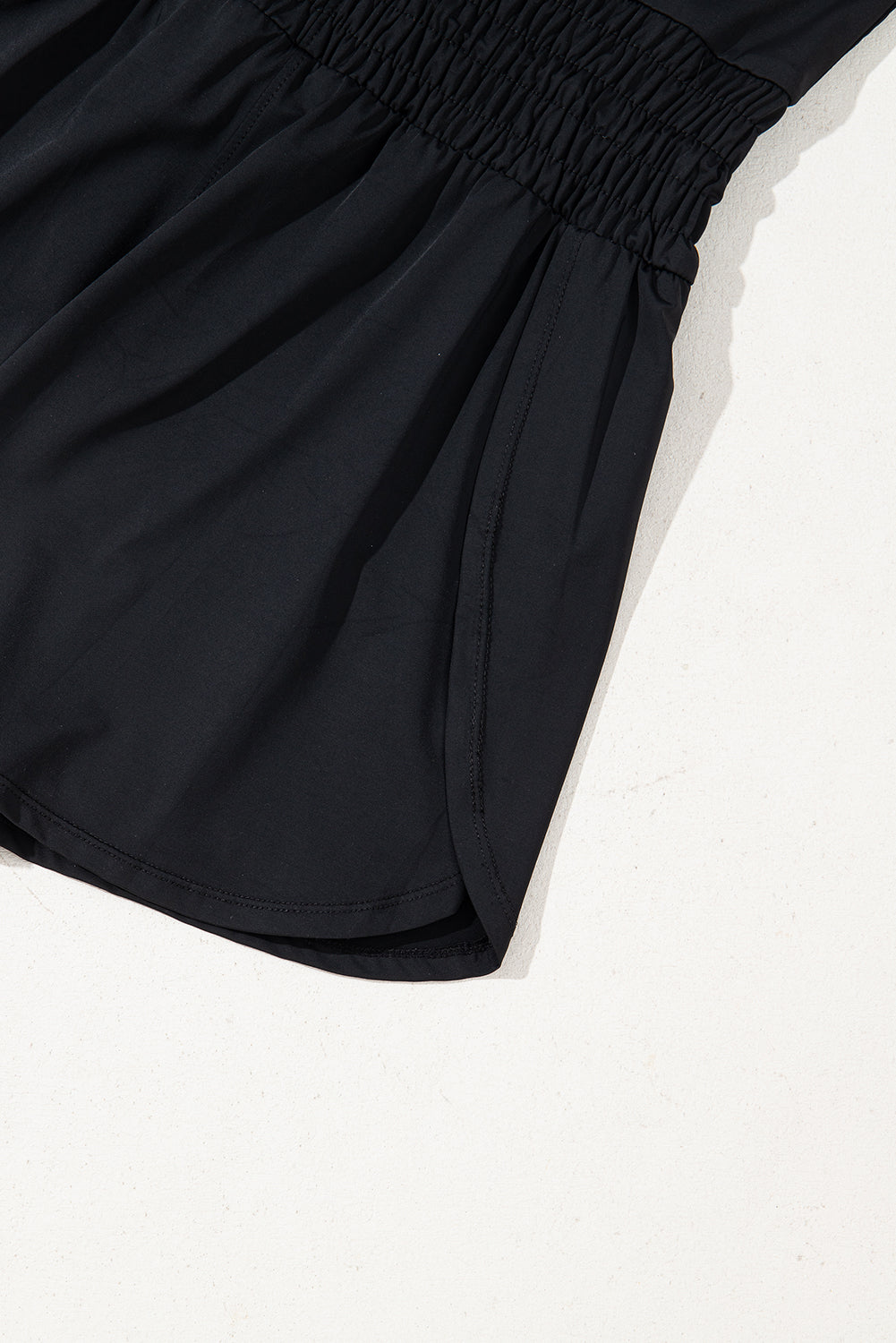 Plain sleeveless Mommas Hive romper with drawstring cinched waist and loop detail, made from polyamide and elastane fabric.