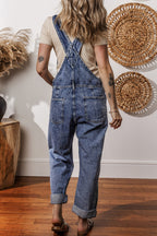 Mommas Hive Sail Blue Denim Bib Jumpsuit with straight legs and pockets, made of cotton-polyester blend, shown flat.