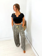 Green pajama pants with Sleepy Sprinkles pattern and satin bow from Mommas Hive, featuring soft, comfortable sleepwear bottoms.