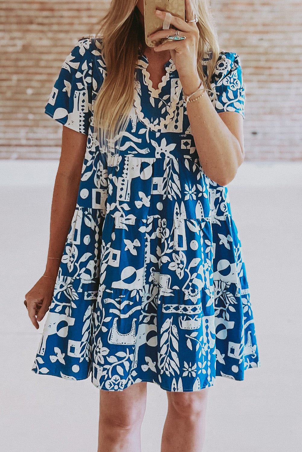 Blue floral loose dress with ricrac trim and split neck from Mommas Hive, made of lightweight polyester fabric.