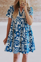 Blue floral loose dress with ricrac trim and split neck from Mommas Hive, made of lightweight polyester fabric.
