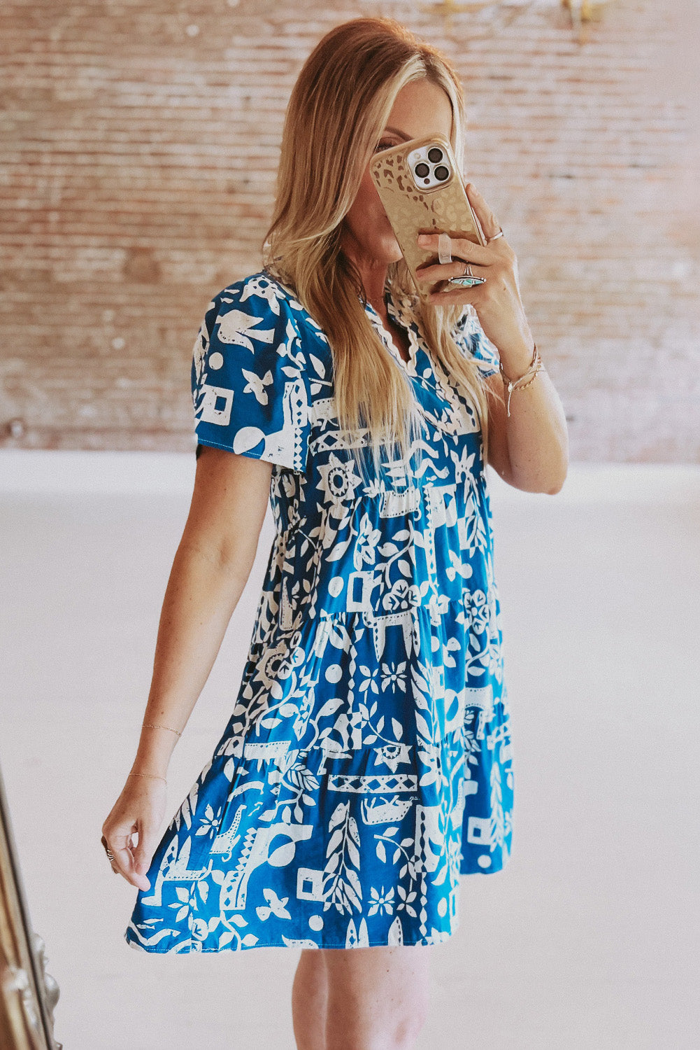 Blue floral loose dress with ricrac trim, split neck, and relaxed fit by Mommas Hive, made from 100% polyester.