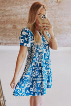 Blue floral loose dress with ricrac trim, split neck, and relaxed fit by Mommas Hive, made from 100% polyester.