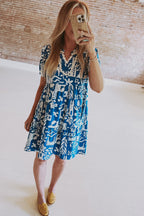 Blue floral dress by Mommas Hive with ricrac trim, split neck, loose fit, and lightweight polyester fabric.
