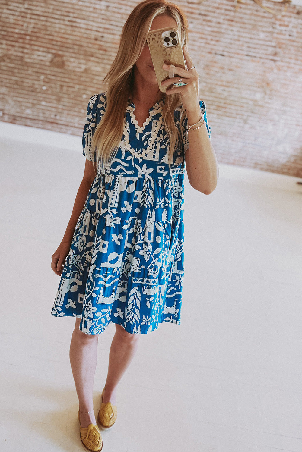Blue floral dress by Mommas Hive with ricrac trim, split neck, loose fit, and lightweight polyester fabric.