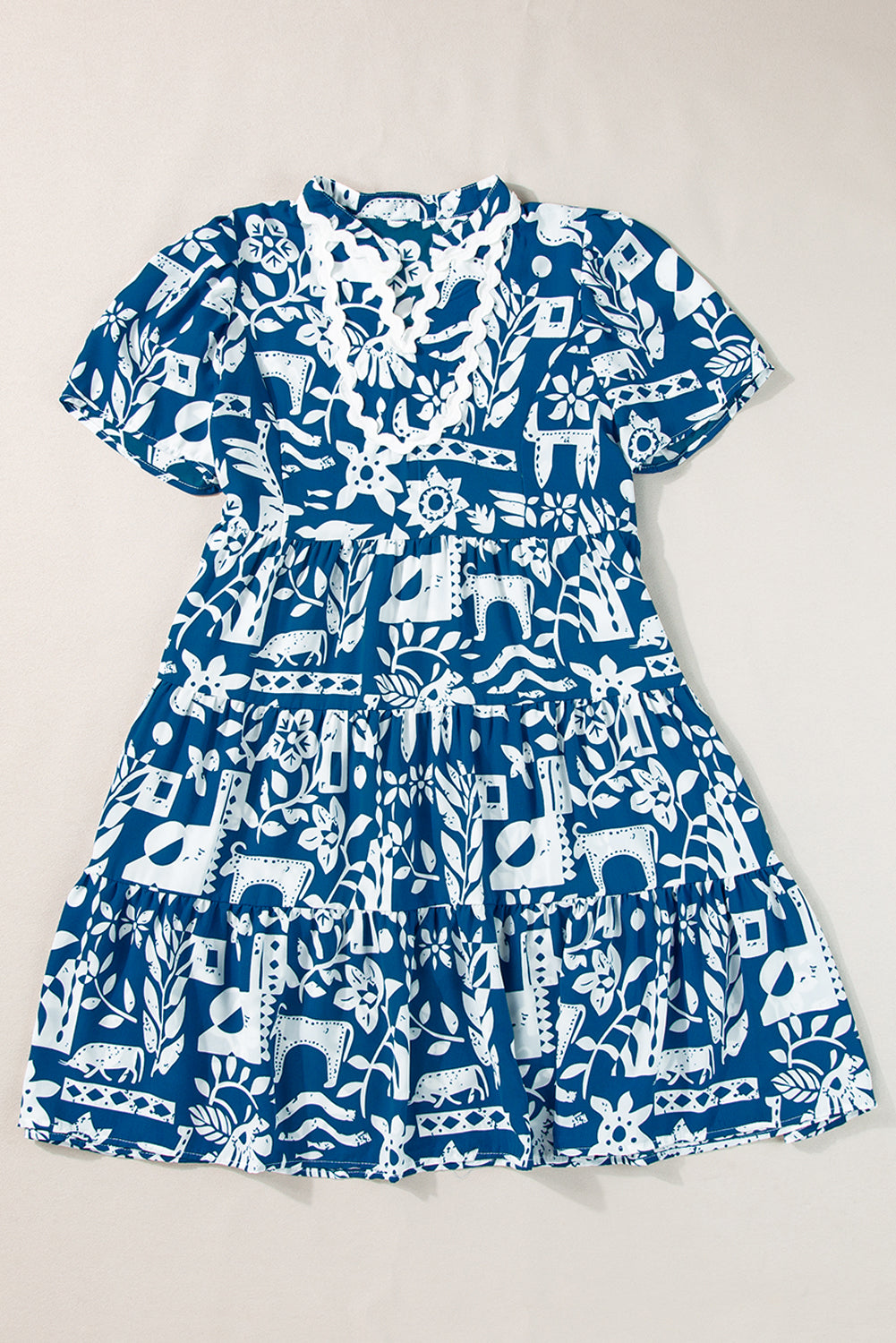 Blue floral loose dress with ricrac trim, split neck, and short sleeves from Mommas Hive, made of lightweight polyester fabric.