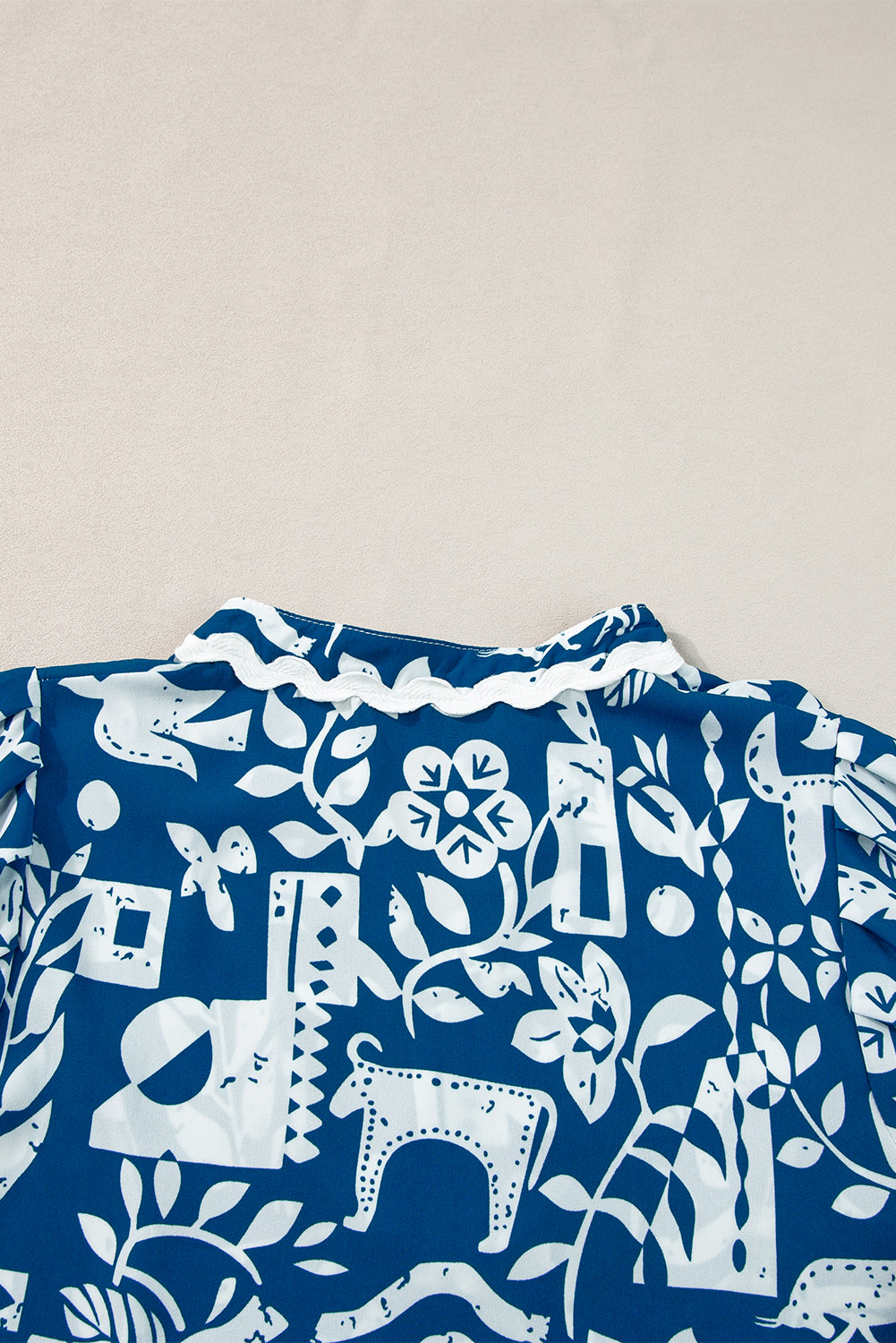 Blue floral loose dress with ricrac trim, split neck, short sleeves, by Mommas Hive, made of lightweight polyester fabric.