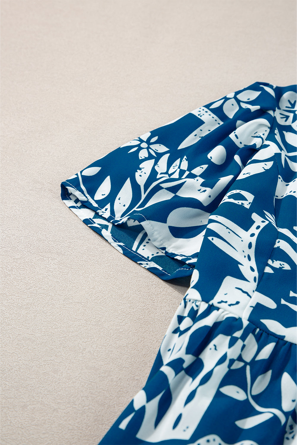 Blue floral dress by Mommas Hive featuring ricrac trim, split neckline, and loose fit in lightweight polyester fabric.