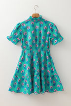 Green floral print high waist mini dress with frilly and smocked details by Mommas Hive, featuring a stylish, summery design.