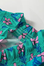 Green floral print mini dress by Mommas Hive with frilly details, smocked waist, and high waist fit, perfect for summer occasions.