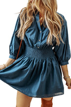 Prussian Blue Mommas Hive mini dress with 3/4 sleeves, shirred high waist, and button details, made of 100% cotton.