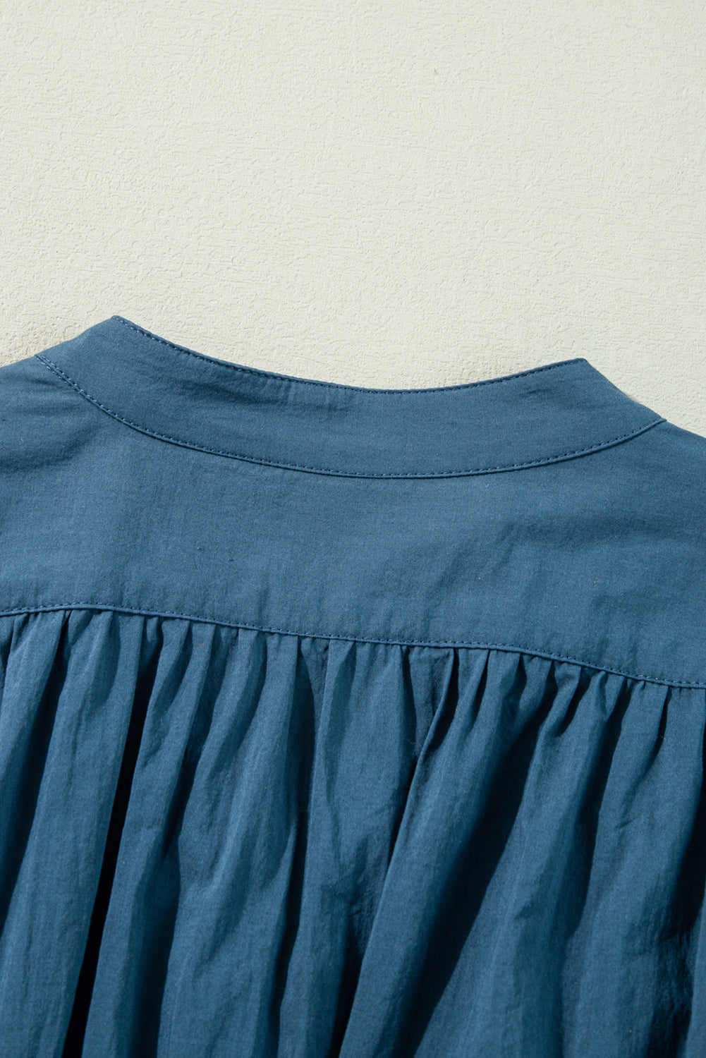 Prussian Blue Mommas Hive mini dress with 3/4 sleeves, shirred high waist, and button details, made of 100% cotton.