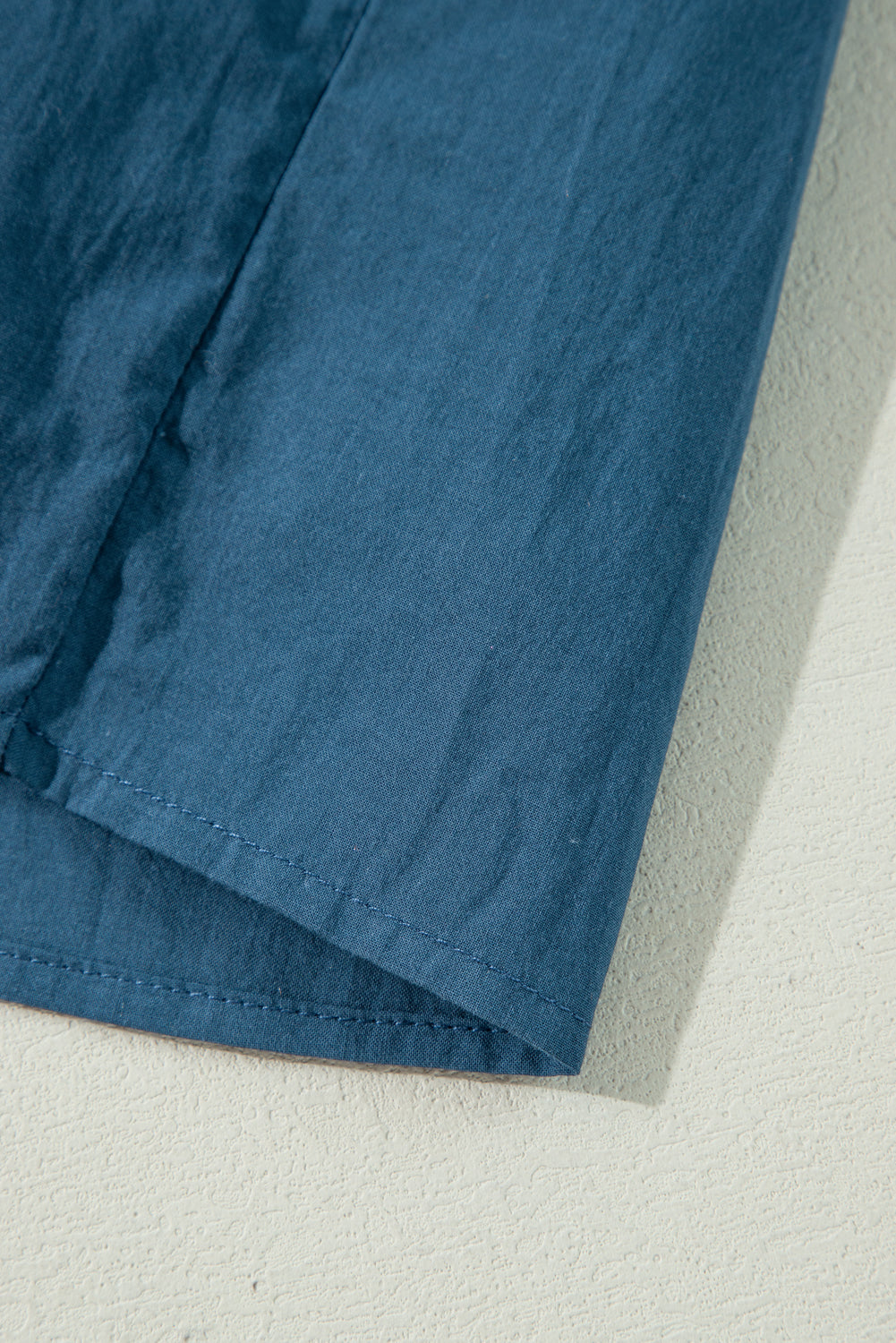 Prussian Blue 3/4 sleeve shirred high waist buttoned mini dress by Mommas Hive, made of 100% cotton, showing front view.