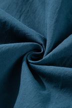 Mommas Hive Prussian Blue mini dress with 3/4 sleeves, shirred high waist, and button front, made of 100% cotton.