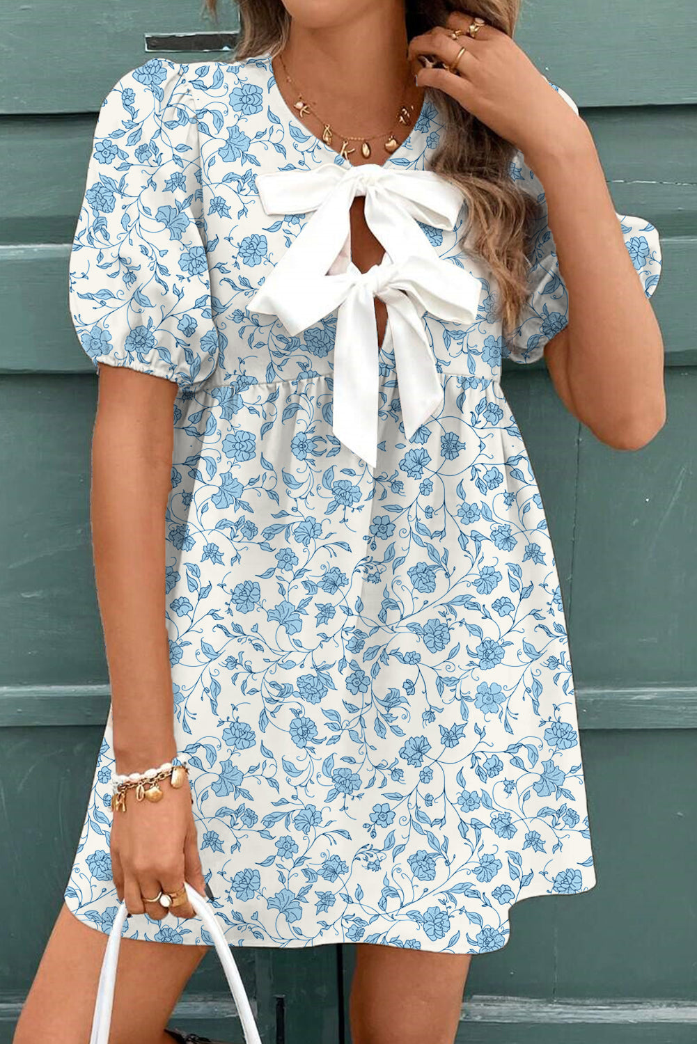 Sky blue floral contrast bow puff sleeve mini dress by Mommas Hive, showcasing a fitted mini dress with puff sleeves and bow detail.