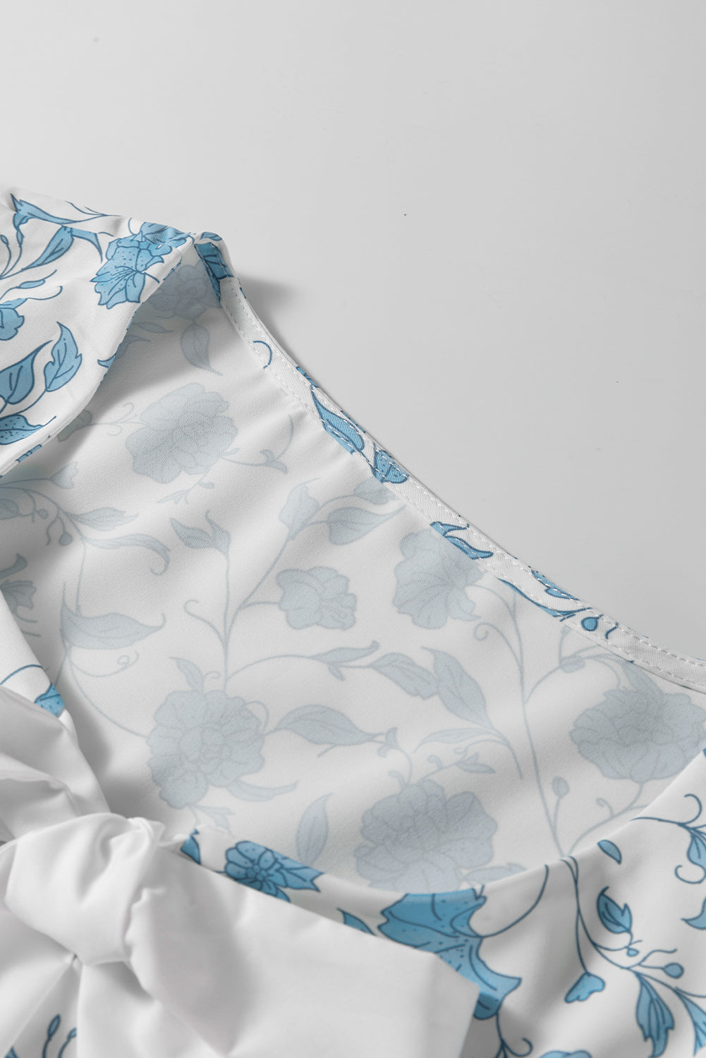 Sky blue floral contrast bow puff sleeve mini dress by Mommas Hive, featuring a fitted silhouette and delicate floral print.