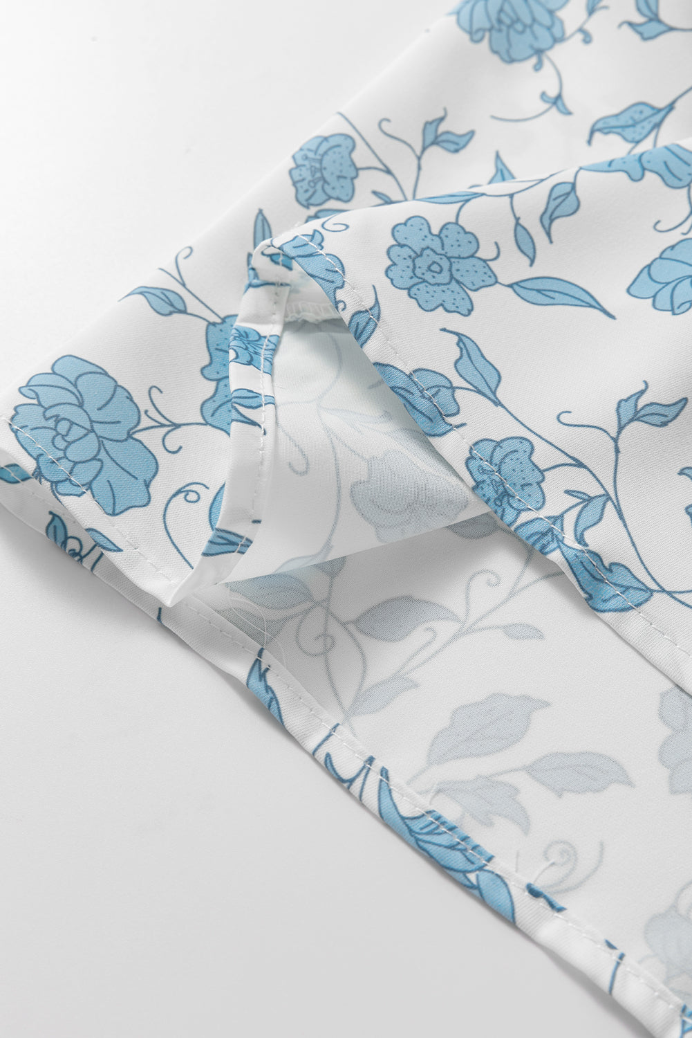 Sky blue floral contrast bow puff sleeve mini dress by Mommas Hive, showcasing a fitted silhouette and delicate floral pattern.