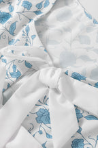 Sky blue floral contrast bow puff sleeve mini dress by Mommas Hive, featuring a fitted silhouette and delicate floral pattern.