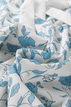 Sky blue floral contrast bow puff sleeve mini dress by Mommas Hive, featuring a fitted silhouette and delicate floral pattern.