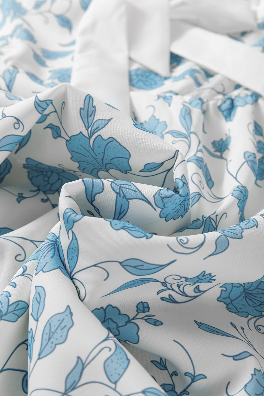 Sky blue floral contrast bow puff sleeve mini dress by Mommas Hive, featuring a fitted silhouette and delicate floral pattern.