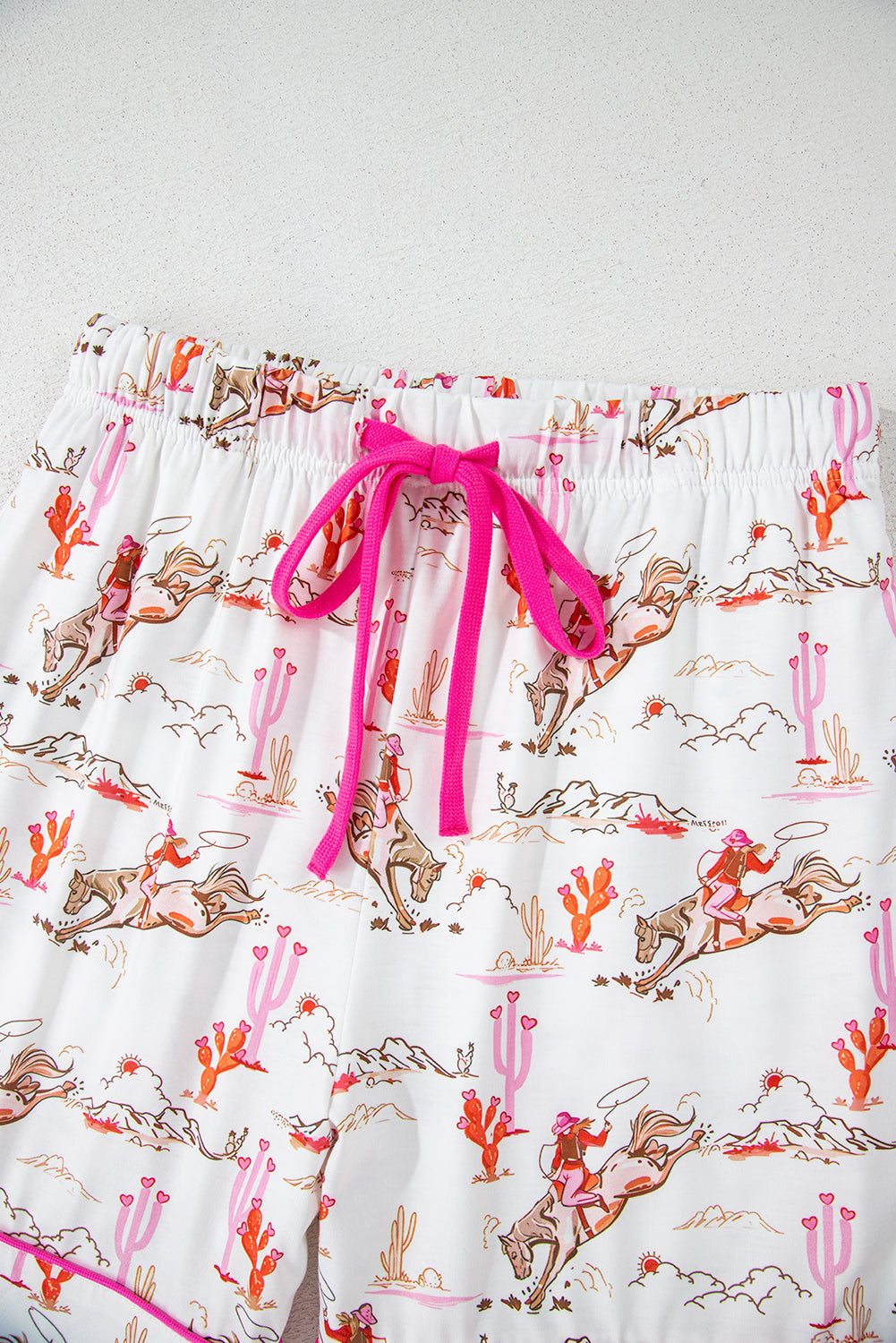 White cowgirl country print pajamas set from Mommas Hive, soft loungewear with comfortable polyester and elastane blend.
