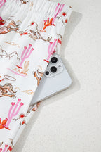 White cowgirl country print pajamas set from Mommas Hive, soft loungewear with comfortable polyester and elastane blend.